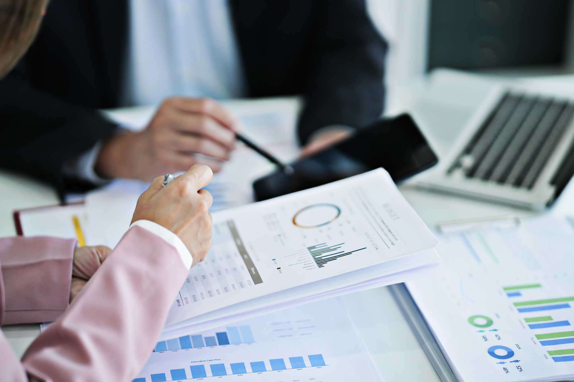 close up of professionals writing on a notebook