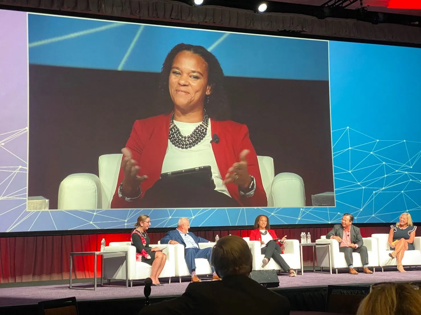 Apryl speaks on stage